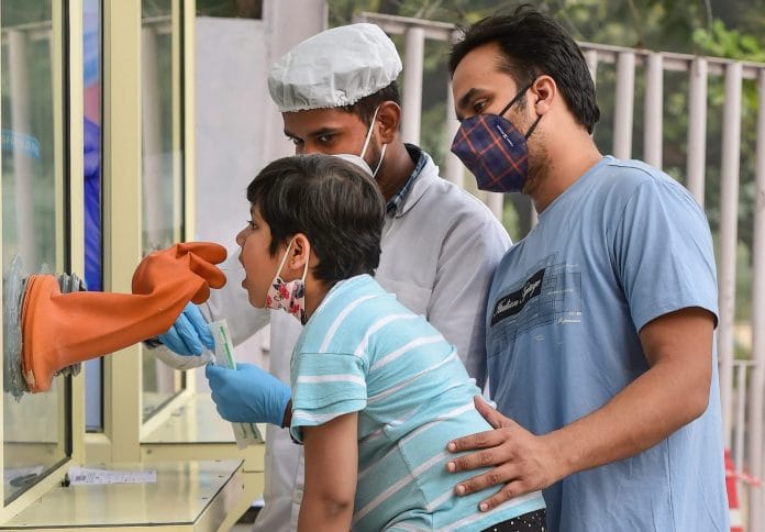 A health worker collects swab samples for Covid-19 test, in New Delhi 9 November 2020. | PTI/Kamal Kishore