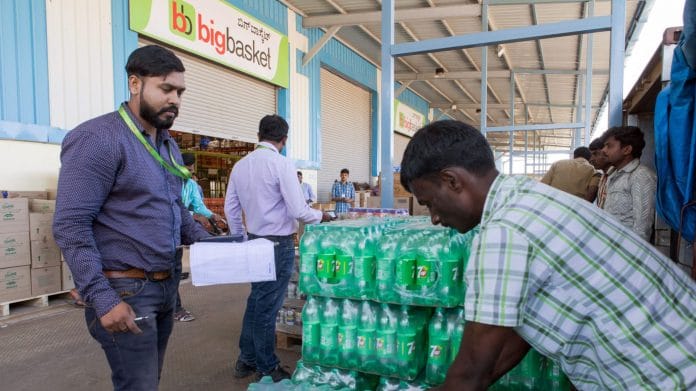 Workers unload crates at a warehouse of Bigbasket, in Bengaluru in 2018. | Photographer: Samyukta Lakshmi | Bloomberg