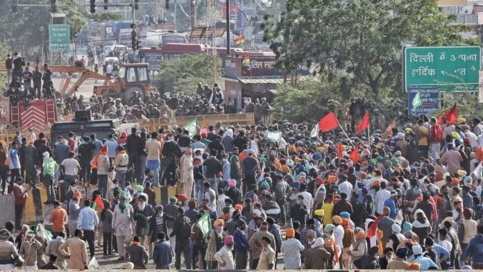 Farmers stand in front of police barricades at the Singhu Border between Delhi and Haryana Friday | Photo: Manisha Mondal | ThePrint