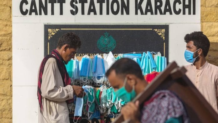 A vendor sells protective masks from a street stall at Karachi Cantonment railway station, known as Cantt Sation, in Karachi, Pakistan, on July 28, 2020 | Asim Hafeez | Bloomberg
