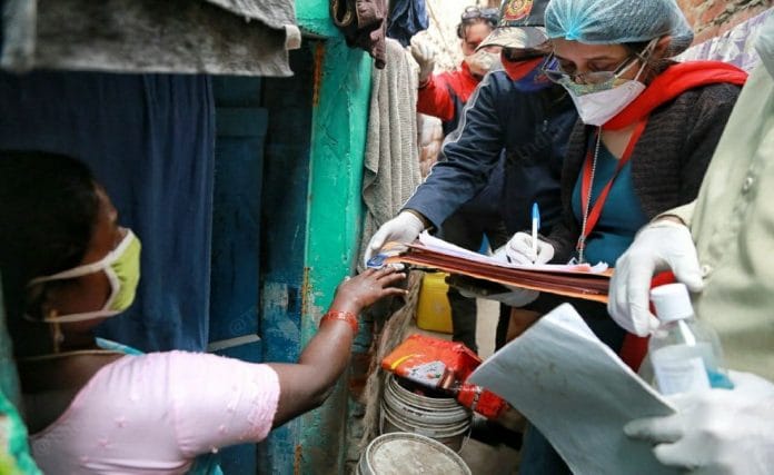 A survey team of the Southeast Delhi district meets residents at Madrasi Basti near Lajpat Nagar | Manisha Mondal | ThePrint
