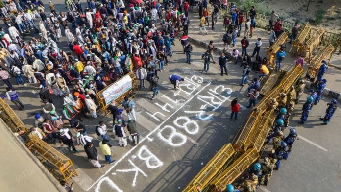 Bharatiya Kisan Union (BKU) members protest after police imposed section 144 at Ghazipur border, during their Delhi Chalo march against the new farm laws, in New Delhi on Monday | Photo by Suraj Singh Bisht | ThePrint