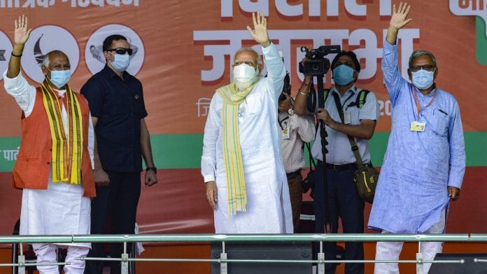 Prime Minister Narendra Modi and MP Janardan Singh Sigriwal wave at the crowd during an election rally for the second phase of Bihar Assembly polls, at Chhapra, Sunday, Nov. 1, 2020. | PTI