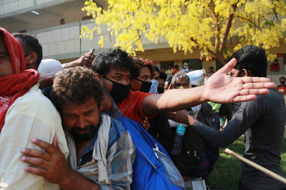 Thousands of migrant workers from Bihar gathered at a school in Delhi Chhatarpur as they receive message with boarding details. Desperate to reach home, migrant workers fight to get ahead in the queue | Manisha Mondal | ThePrint