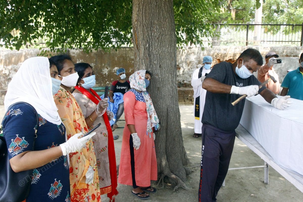 A Christian family at the funeral of their family member at Alpha Omega Christian Welfare Cemetery in Mongolpuri that is designated as Covid cemetery | Photo: Praveen Jain | ThePrint