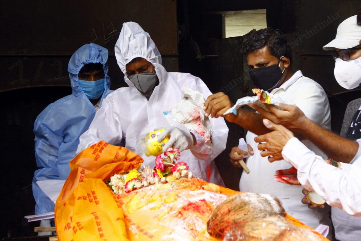 At one of the cremation ground of Surat, Abdul Rehman Malbari, who is the care taker, gives Gangajal to the deceased in with accordance with Hindu last rites | Praveen Jain | ThePrint