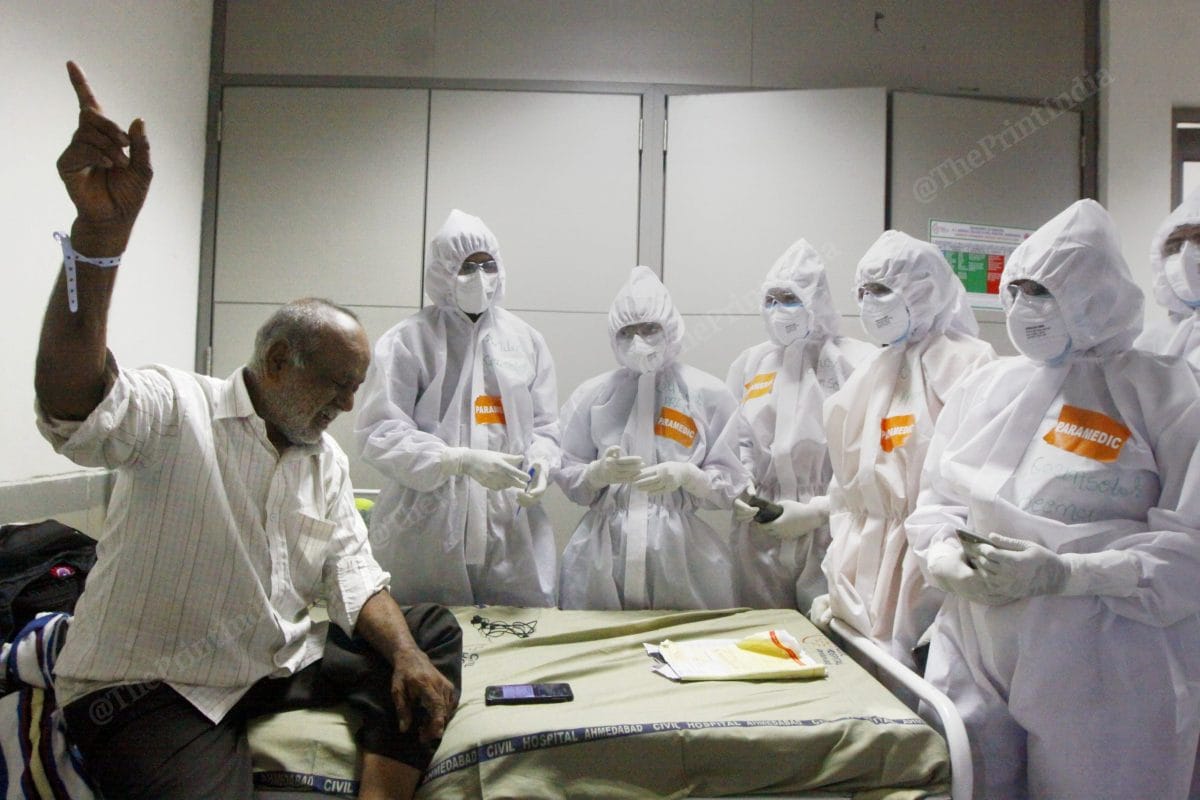 Amrit Bhai Panchal, a 64-year-old Covid-19 patient, sings 'Gulaabi aankhein' for a group of doctors and paramedics to lighten the mood inside the covid ward of a hospital in Ahmedabad | Photo: Praveen Jain | ThePrint