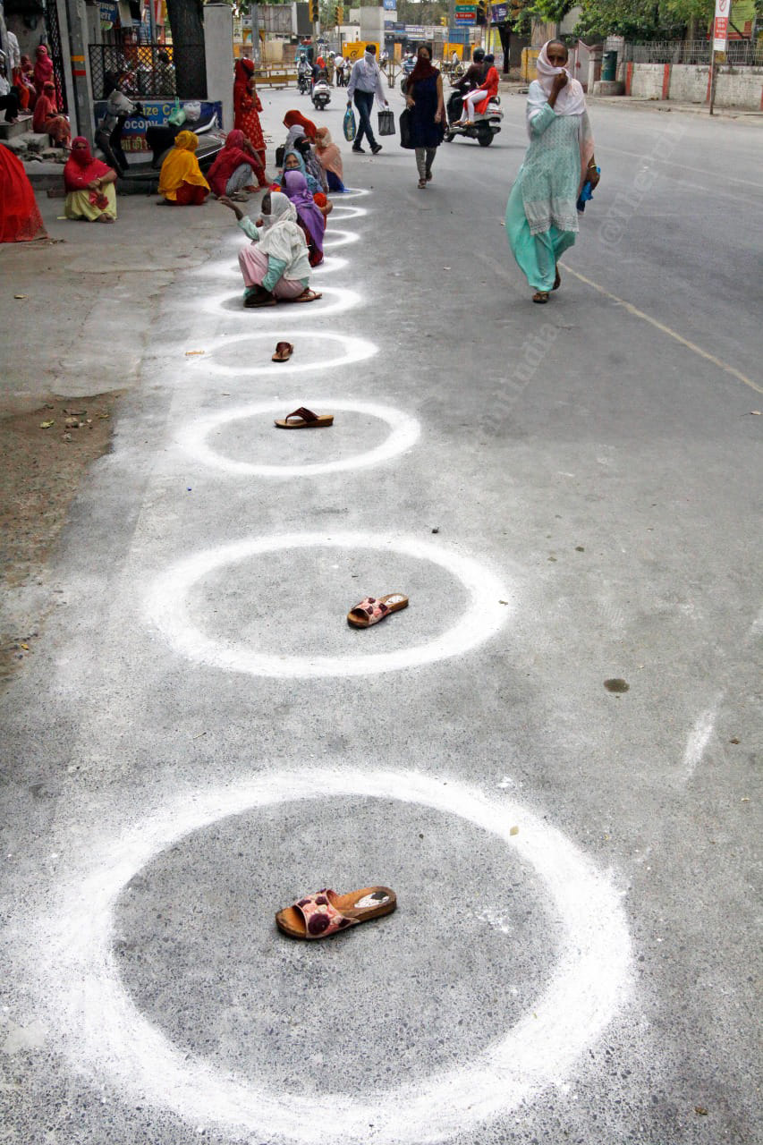 In Uttar Pradesh, people have kept their shoes to secure a place in the food distribution queue | Photo: Praveen Jain | ThePrint