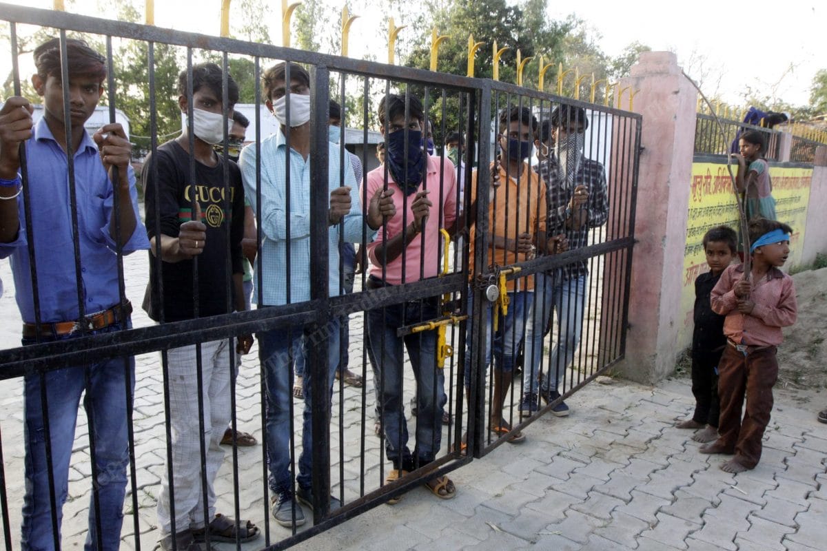 In Sitapur, Uttar Pradesh, children stand at the main gate of village school that has been converted into an isolation centre | Photo: Praveen Jain | ThePrint