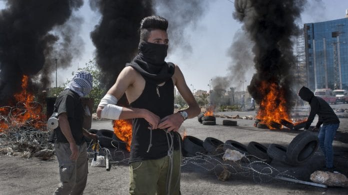 A Palestinian protester during clashes near Beit El, in Ramallah, West Bank | Photo: Geraldine Hope Ghelli | Bloomberg File Photo