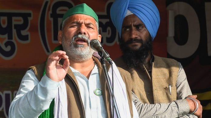Bharatiya Kisan Union Spokesperson Rakesh Tikait addresses farmers during their ongoing protest against the new farm laws, at Ghazipur border in New Delhi, on 28 January, 2021 | PTI