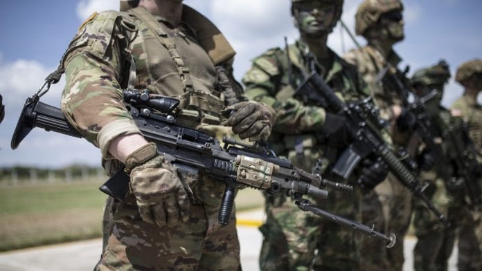 An American soldier holds a M249 light machine gun during multinational military exercises. | Representational Image | Photographer: Ivan Valencia | Bloomberg