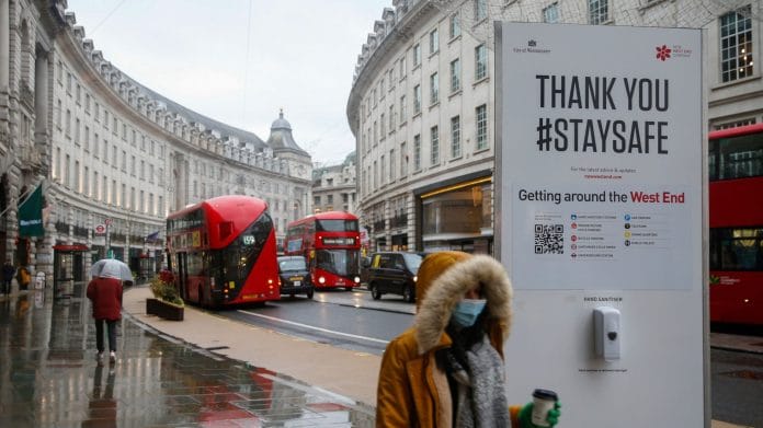 A pedestrian walks along Regent Street in London on Jan. 5. | Photographer: Hollie Adams | Bloomberg