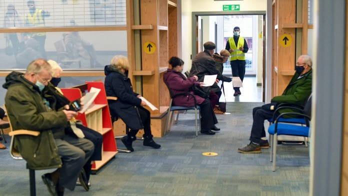 A staff member calls through visitors to receive the AstraZeneca vaccine at the in Oldham, UK (representational imahe) | Photographer: Anthony Devlin | Bloomberg