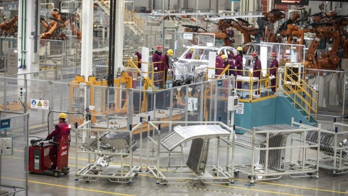 Employees work on the assembly line of carmaker Nio's production facility in Hefei, Anhui province, China