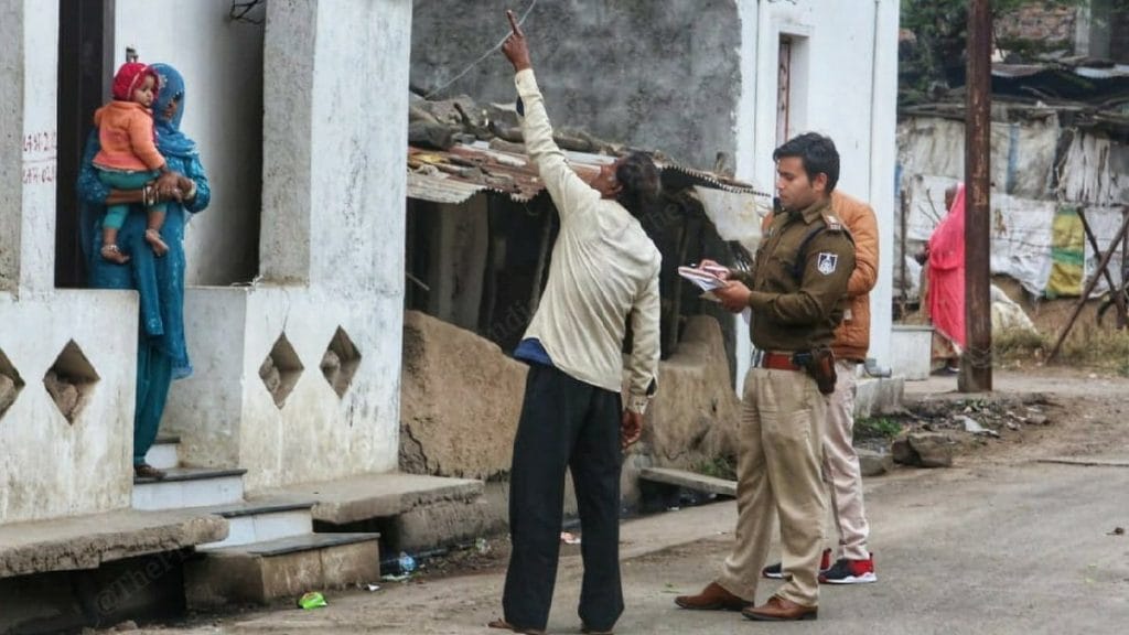 A local resident recounts the day of the violence to a policeman in Dorana, Mandsaur | Photo: Praveen Jain | ThePrint