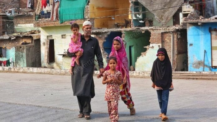 Abdul Hamid with his children in front of their demolished home in Begum Bagh, Ujjain, Madhya Pradesh | Photo: Praveen Jain | ThePrint