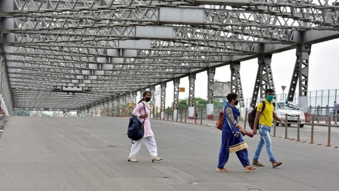 Representational image of people walking across West Bengal's iconic Howrah Bridge | File photo: ANI