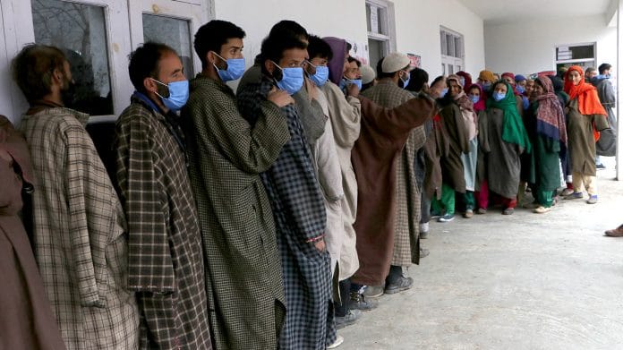 Voters stand in a queue to cast their votes for the DDC elections in Anantnag, on 4 December 2020 | ANI Photo