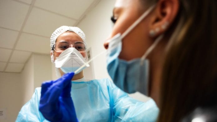 A health care worker administers a Covid-19 swab test at Toulouse Purpan University Hospital in Toulouse, France (File photo) | Photographer: Matthieu Rondel | Bloomberg