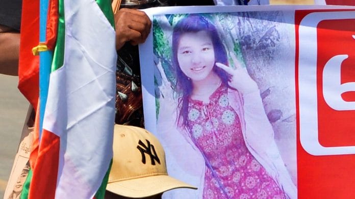 People holds up banner with an image of Mya Thwe Thwe Khine in Naypyidaw on 17 February | Photographer: STR/AFP/Getty Images via Bloomberg