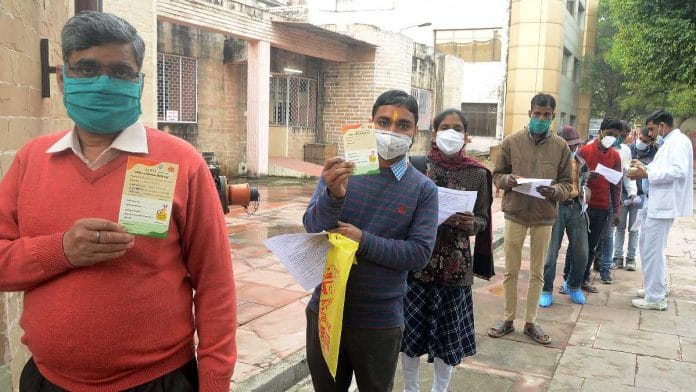 Beneficiaries show their vaccination report card after getting the Covid-19 vaccine, in Lucknow on 5 February 2021 | ANI