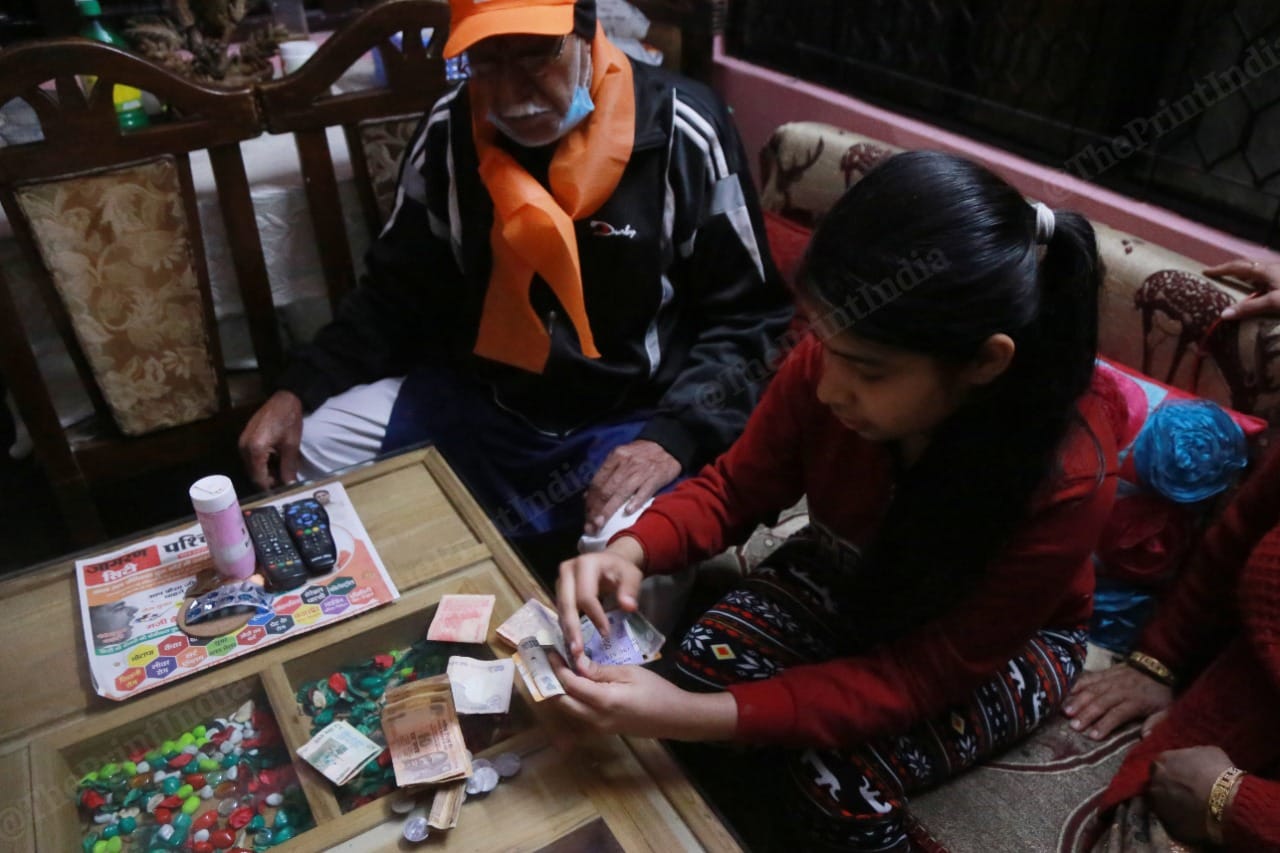 14-year-old Aarna Tanwar breaks her gulak (piggybank) to donate Rs 750 to the Ram temple | Photo: Manisha Mondal/ThePrint.