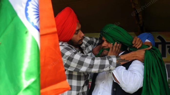 A farmer getting turban tied on 'Pagdi Sambhal Diwas' at the Ghazipur border protest site. | Photo: Suraj Singh Bisht/ThePrint