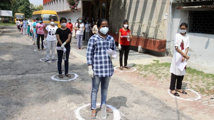 Students wait outside an exam centre as they arrive to appear for the NEET exam, in Lucknow, on 13 September 2020 | ANI File Photo
