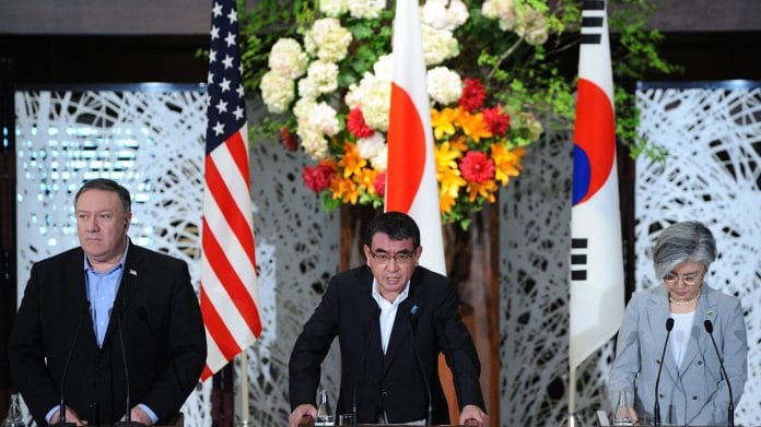 Taro Kono, Japan's foreign minister, (Center) speaks as Mike Pompeo, former US secretary of state (Left), and Kang Kyung-Wha, South Korea's foreign minister (Right) listen during a news conference in Tokyo, Japan, on Sunday, July 8, 2018. | Photographer: David Mareuil | Pool via Bloomberg