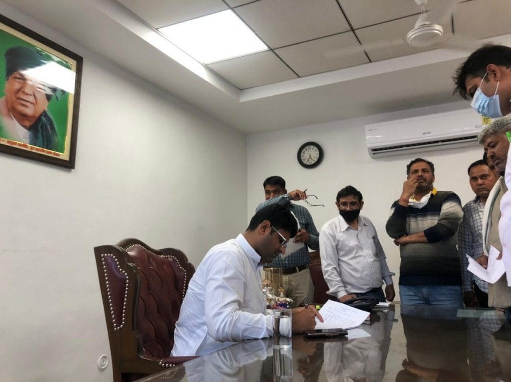 Haryana Deputy CM Dushyant Chautala at work, with a portrait of his great-grandfather Devi Lal behind him | Photo: Jyoti Yadav | ThePrint