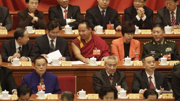 Gyaltsen Norbu (in red), the Beijing-appointed 11th Panchen Lama, at the 13th Chinese People's Political Consultative Conference in Beijing in 2018 | Qilai Shen | Bloomberg