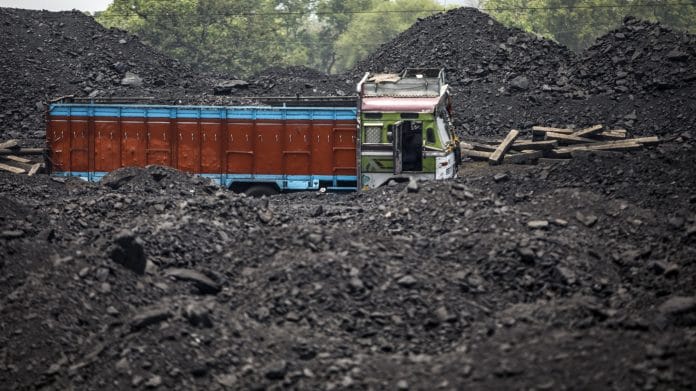 A truck parked next to piles of coal at Tori Siding on the Tori-Shivpur rail line, in Chandwa, Jharkhand | Photographer: Prashanth Vishwanathan | Bloomberg File