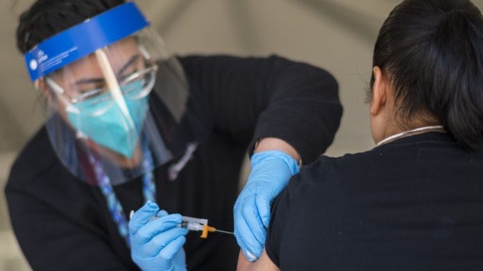 Representative Image | File photo of a healthcare worker administering a dose of the Moderna Covid-19 vaccine to a person in the US | Photographer: Nic Coury | Bloomberg