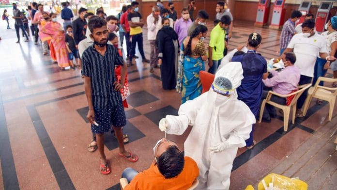 Medics collect swab samples of passengers for Covid tests at Kopar Khairane Railway Station in Navi Mumbai on 5 April 2021. | PTI