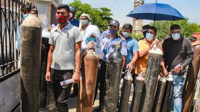 Relatives of Covid patients wait to refill cylinders with medical oxygen, in Gurugram on 25 April 2021 | PTI | Representational image