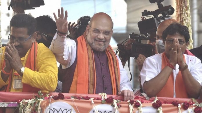 Union Home Minister Amit Shah during a roadshow in support of BJP candidates ahead of the 3rd phase of West Bengal Assembly polls at Baruipur Paschim in South 24 Parganas, on 2 April 2021 | PTI