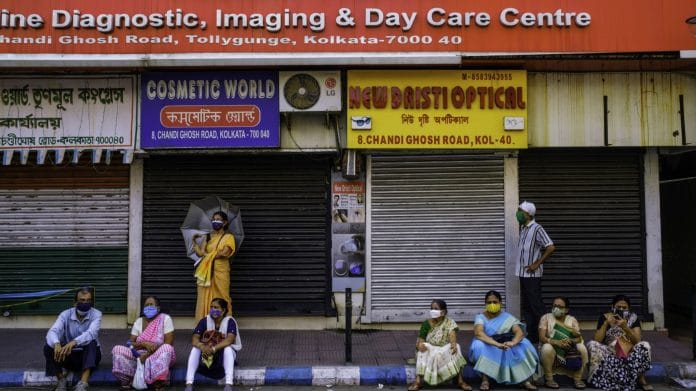 People wait outside a Covid-19 vaccination centre in Kolkata, India, on Wednesday, April 28, 2021. | Photographer: Arko Datto | Bloomberg