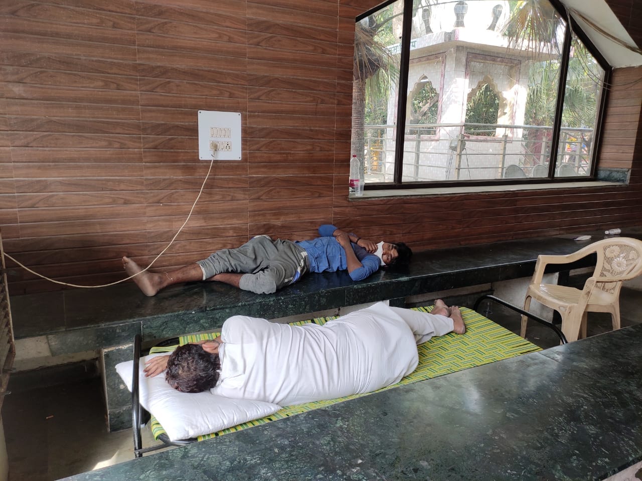 Exhausted crematorium workers at Punjabi Bagh take a break. | Photo: Simrin Sirur/ThePrint