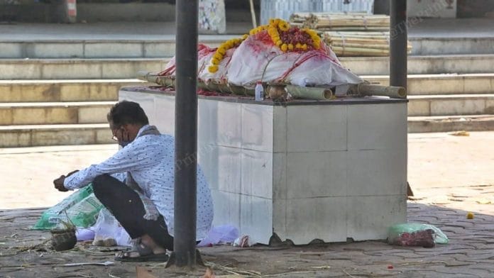 A man waits for his turn to cremate a relative at the Ellisbridge crematorium in Ahmedabad | Praveen Jain | ThePrint