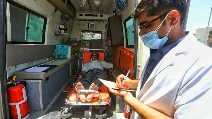 Representational image | A doctor checks details of a patient waiting for hospital admission, in Ahmedabad, Gujarat | Praveen Jain | ThePrint