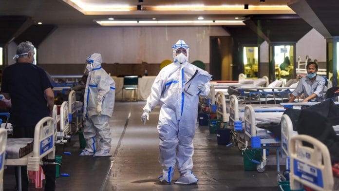 Medics attend to Covid-19 patients at Shehnai Banquet Hall, temporarily converted into an isolation ward, near Lok Nayak Hospital in New Delhi | Photo: PTI