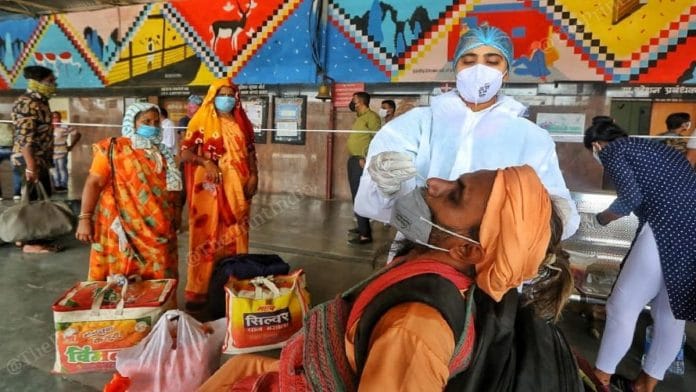 A seer returning from the Kumbh Mela is tested for Covid-19 at the Sabarmati Railway Station in Ahmedabad | Praveen Jain | ThePrint