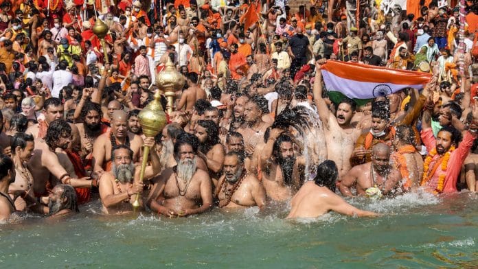 Devotees gather to offer prayers during the third 'Shahi Snan' of the Kumbh Mela 2021, in Haridwar, 14 April 2021 | PTI