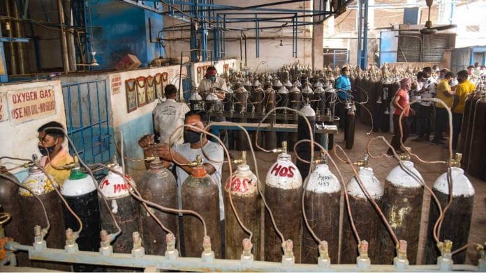 Oxygen refilling Workers refill cylinders with medical oxygen, in Patna, on 27 April 2021 | PTI