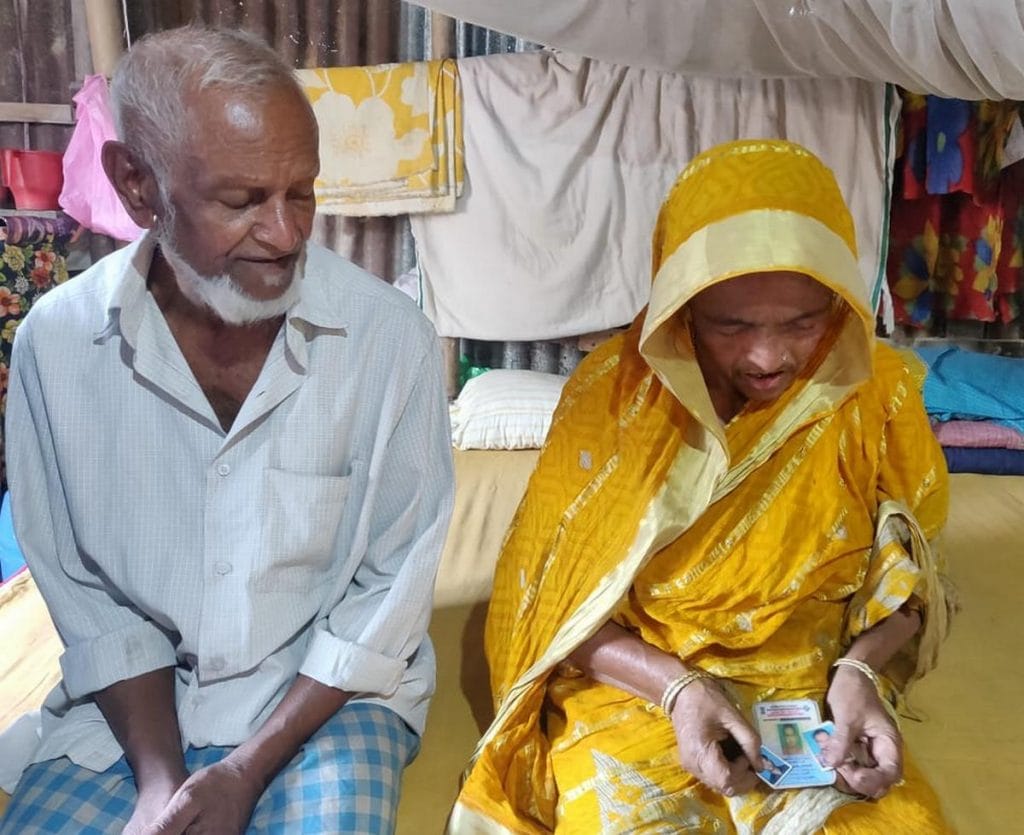 Faizal Vyapari and his wife Sabar Bano, who is holding photos of their three sons who all died by suicide | Photo: Fatima Khan | ThePrint