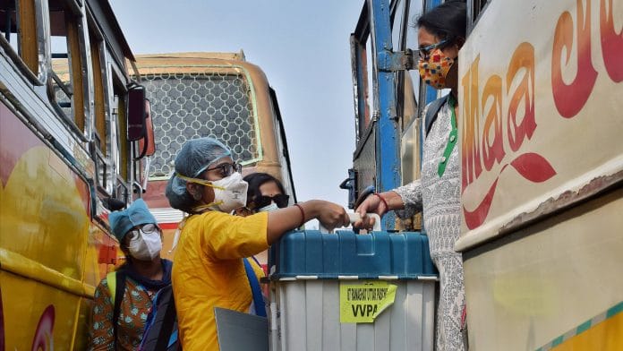 Polling officials carrying EVMS from a distribution centre in Nadia, on 16 April 2021 | PTI Photo