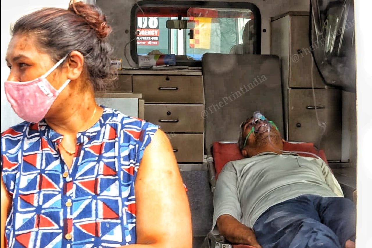 Some family members wait outside the vans while their relatives wait outside | Photo: Praveen Jain | ThePrint