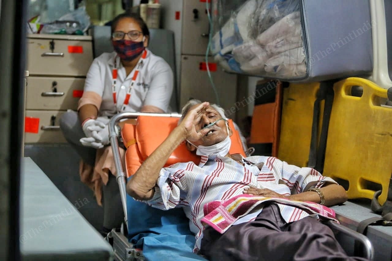 An old man feels sick inside the ambulance | Photo: Praveen Jain | ThePrint