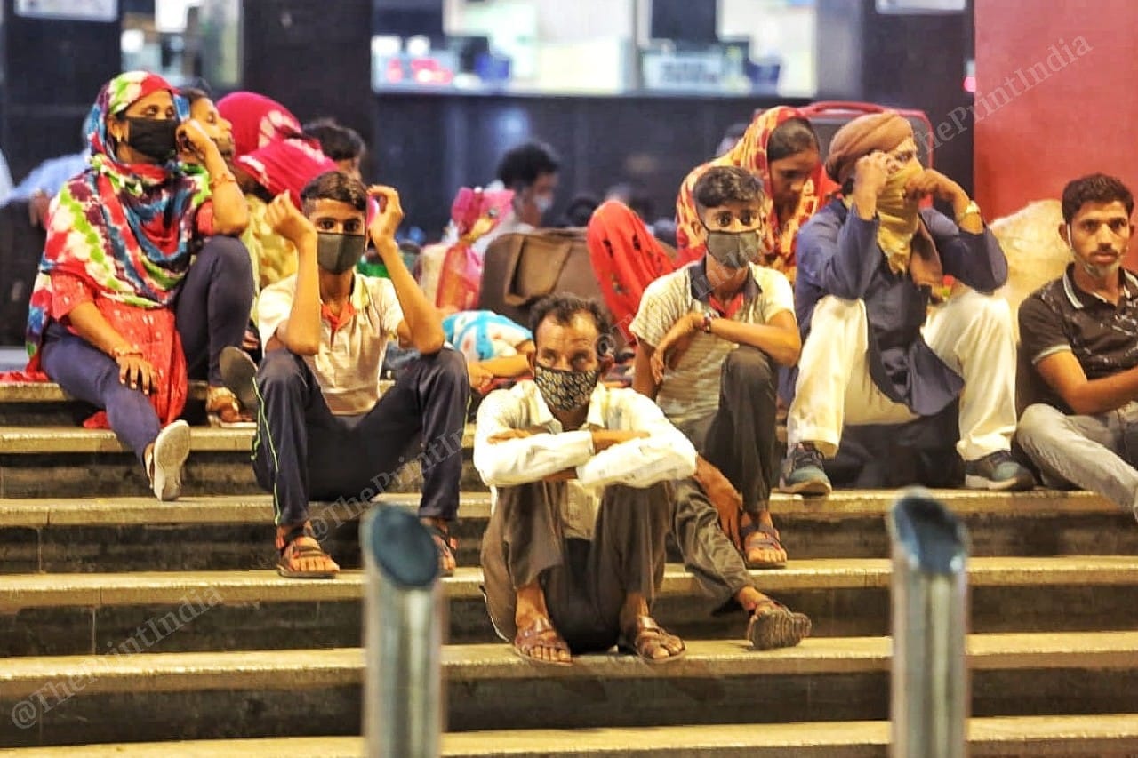 A group of migrant workers going to Bihar wait for their train at the railway station | Photo: Praveen Jain | ThePrint